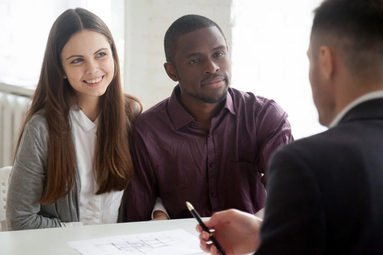 A man and two women are sitting at a table